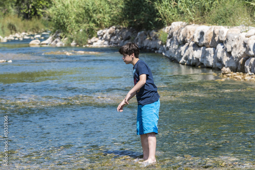 Boy crossing a river