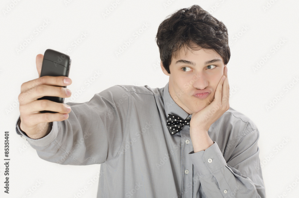 Happy businessman taking a selfie photo with his smart phone. Elegant man holding mobile phone making a duck face. Happy businessman taking a selfie photo with his smart phone. Elegant man holding mobile phone making a duck face.