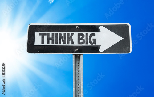 Think Big direction sign with a beautiful day