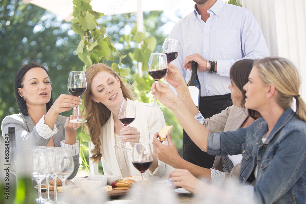 Women enjoying wine tasting session with red wine Women enjoying wine tasting session with red wine