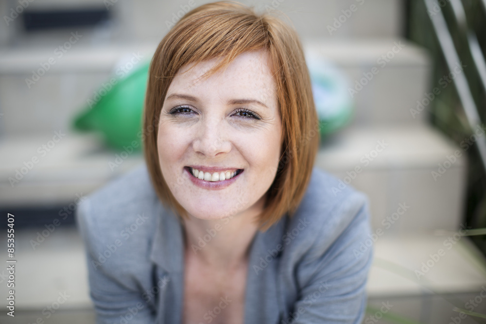 Portrait of young businesswoman sitting on stairs Portrait of young businesswoman sitting on stairs