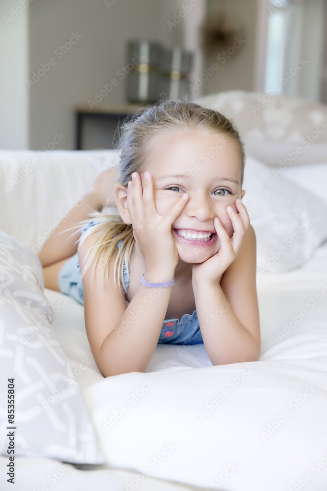 Little girl lying on sofa, laughing Little girl lying on sofa, laughing