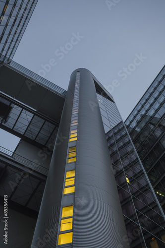 Germany, Munich, facades of office tower at evening twilight