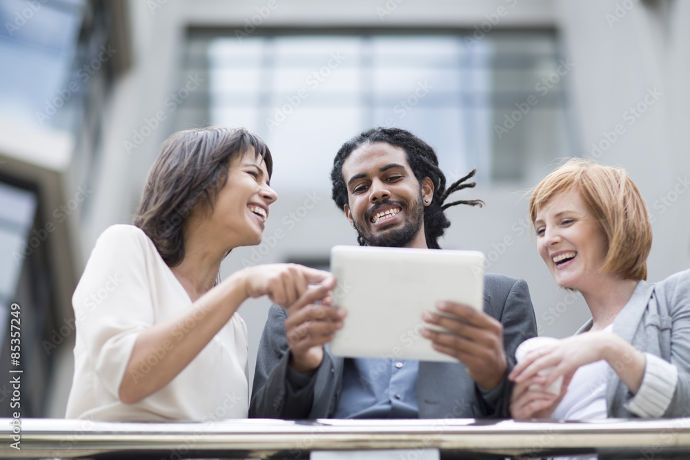 Business people standing on balcony, using digital tablet Business people standing on balcony, using digital tablet