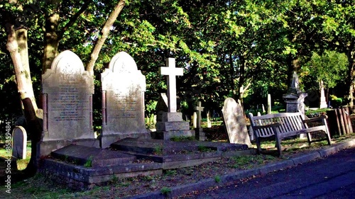 statues, crosses and tumbs in a cemetery photo