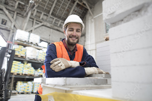 Smiling warehouseman in storehouse