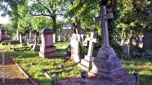 statues, crosses and tumbs in a cemetery photo