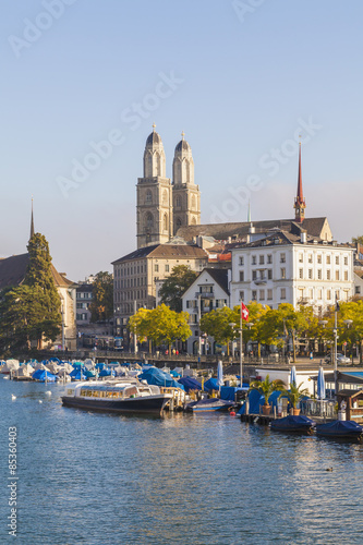 Switzerland, Zurich, River Limmat and pleasure boat at Uto Quai, Great Minster in the background photo