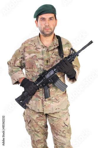  Portrait of young man in army clothes holding a weapon