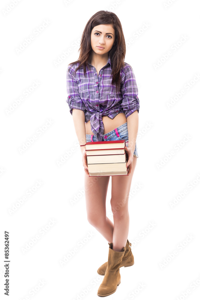 Full length portrait of a beautiful teenage girl holding a pile Full length portrait of a beautiful teenage girl holding a pile