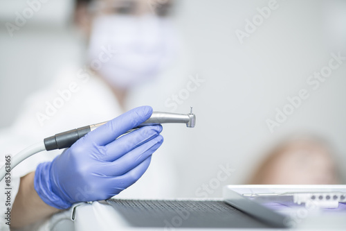 Female dentist holding amalgam carrier