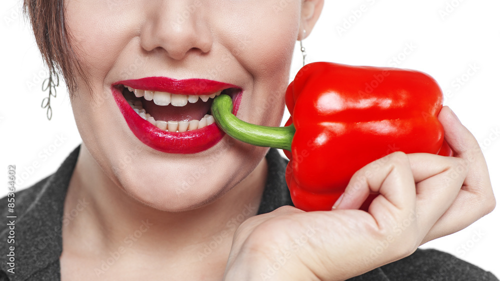 Closeup of the woman face with red pepper isolated Closeup of the woman face with red pepper isolated