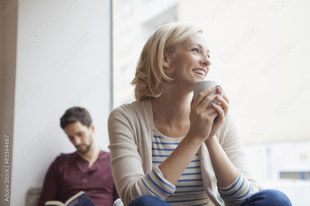 Portrait of happy woman relaxing with cup of tea Portrait of happy woman relaxing with cup of tea