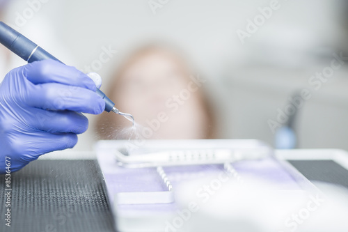 Dentist holding amalgam carrier