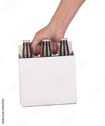 Obraz na plátně Hand holding a six pack of beer bottles