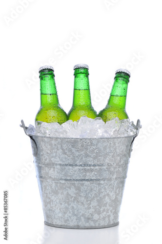 Green beer bottles in a bucket of ice