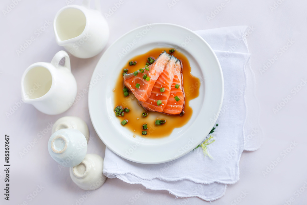 salmon fillet with sauce on white dish