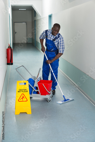 Male Janitor Cleaning Floor