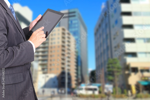 Double exposure of city and business man