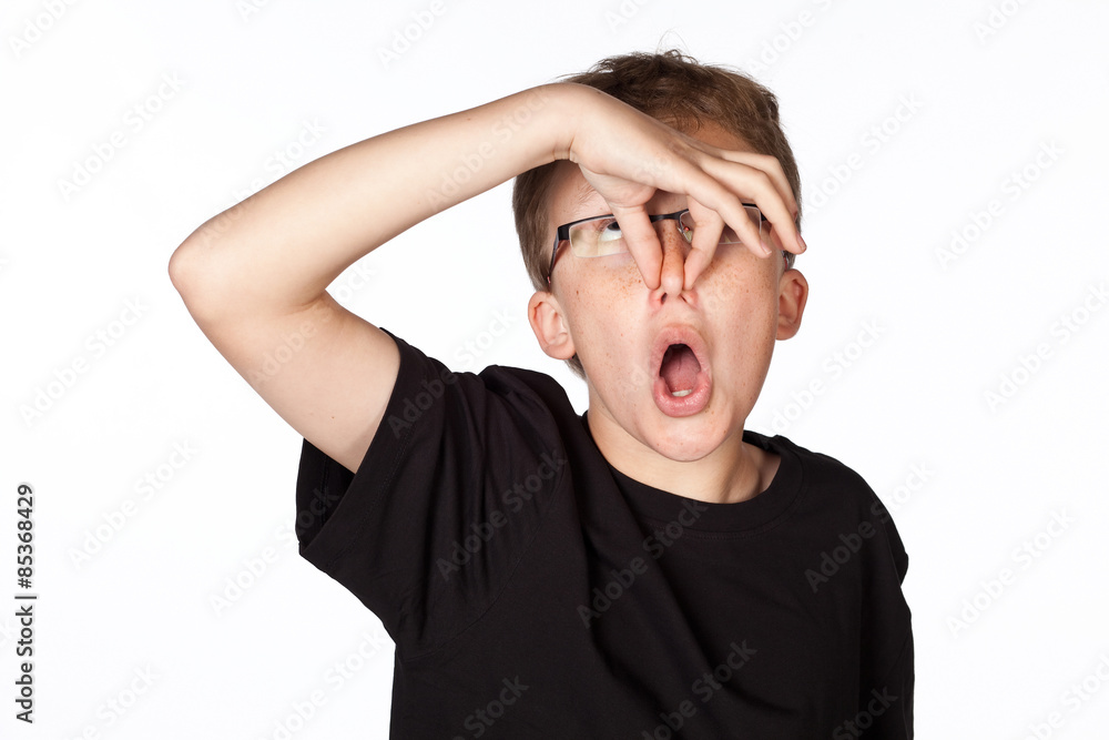 Funny shot of a boy holding his nose isolated on white. Funny shot of a boy holding his nose isolated on white.