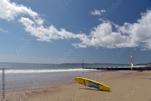 Surfboard on beach at Bournemouth, Dorset