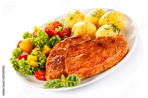 Fried chicken fillets, boiled potatoes and vegetable salad 
