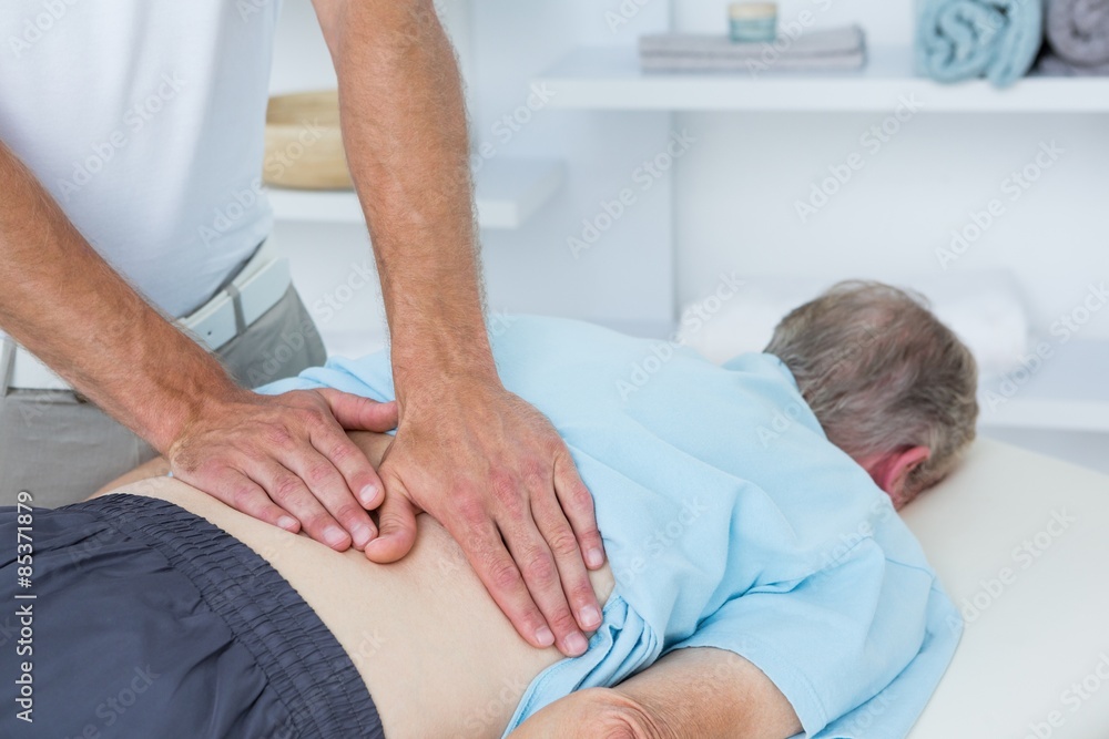 Physiotherapist doing back massage Physiotherapist doing back massage