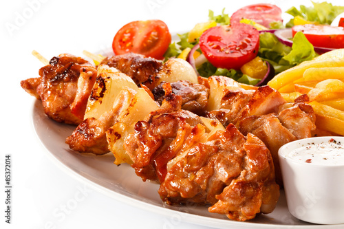 Shashlik - grilled meat  chips and vegetables 