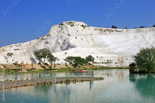 Lake and calcified limestone terraces on background, Pamukkale