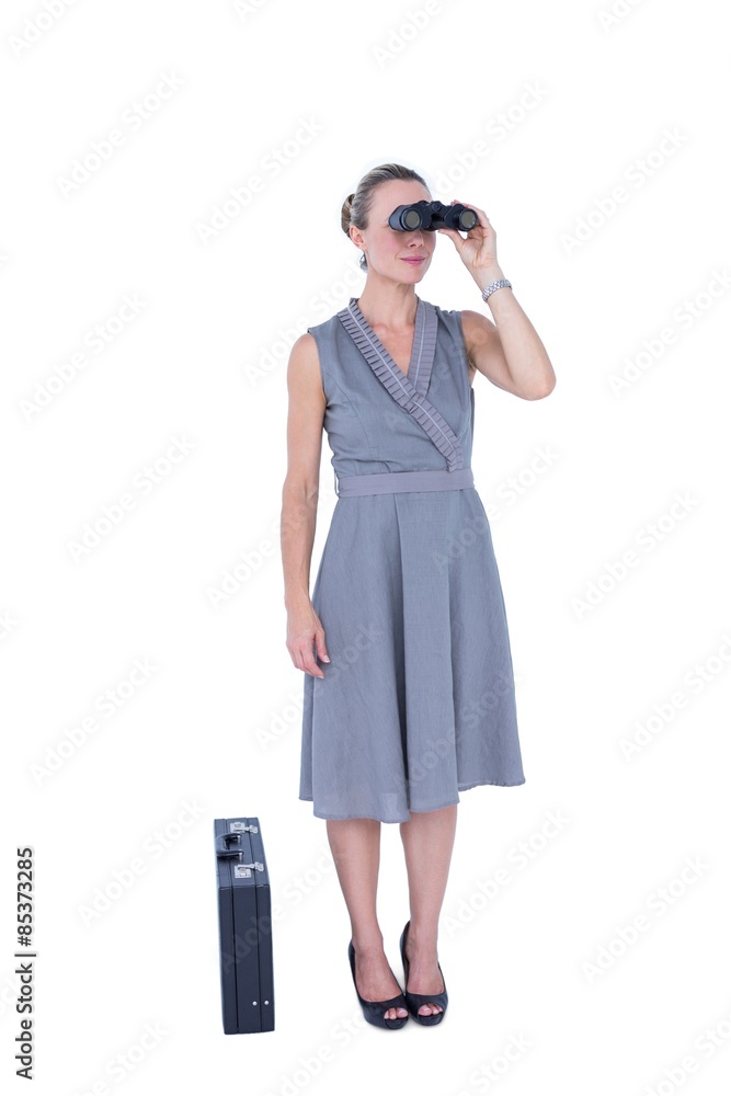 A businesswoman looking through binoculars A businesswoman looking through binoculars