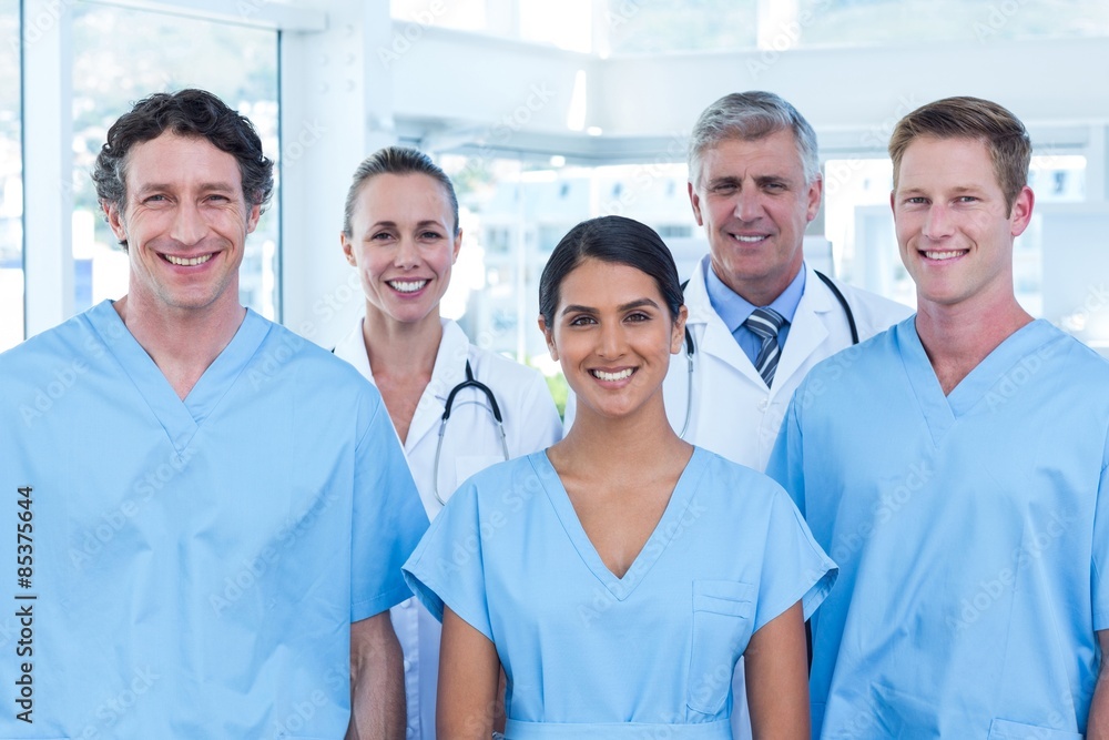 Team of smiling doctors looking at camera Team of smiling doctors looking at camera