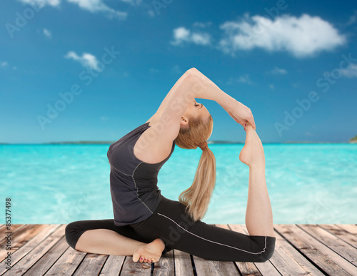 happy young woman doing yoga exercise