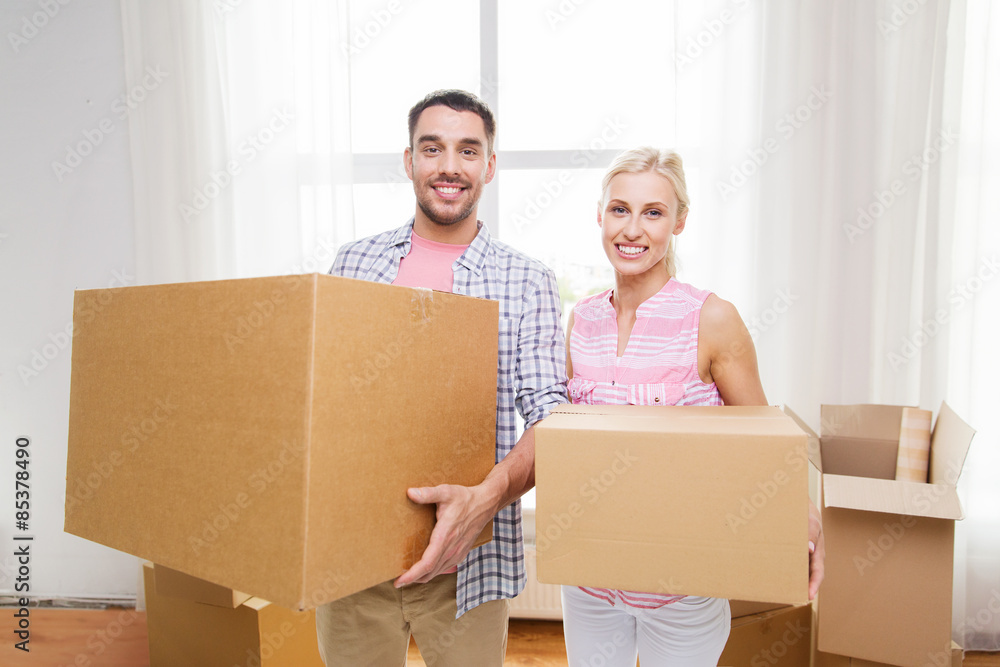couple with big cardboard boxes moving to new home couple with big cardboard boxes moving to new home