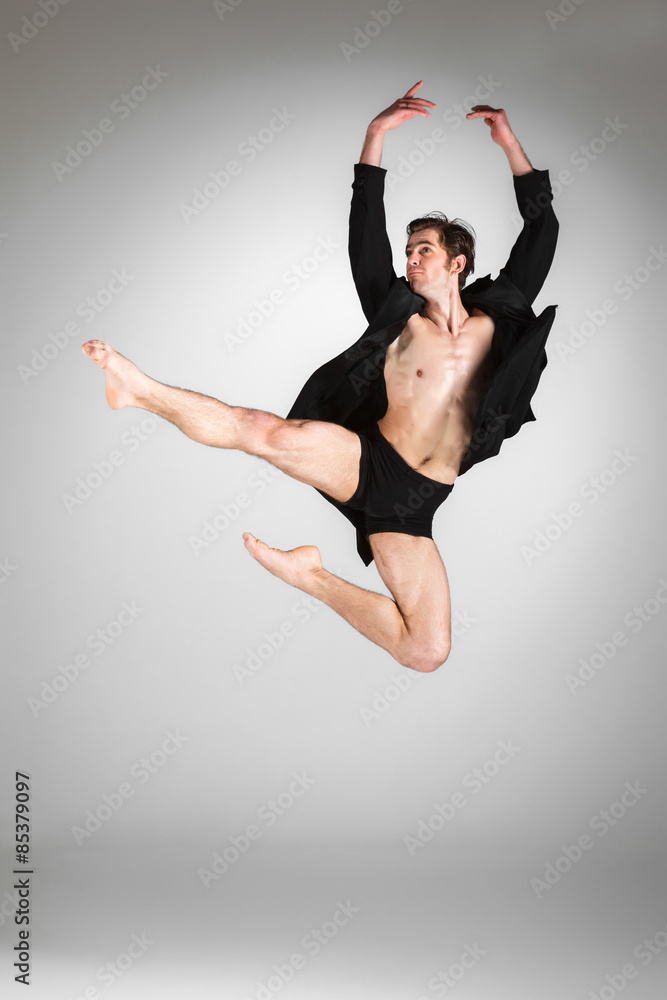 Fototapeta premium The young attractive modern ballet dancer jumping on white