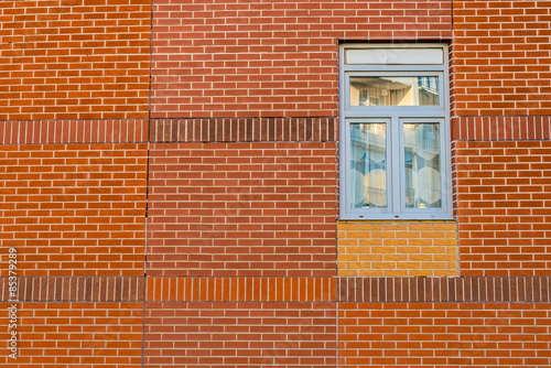 Blue window on a red brick wall