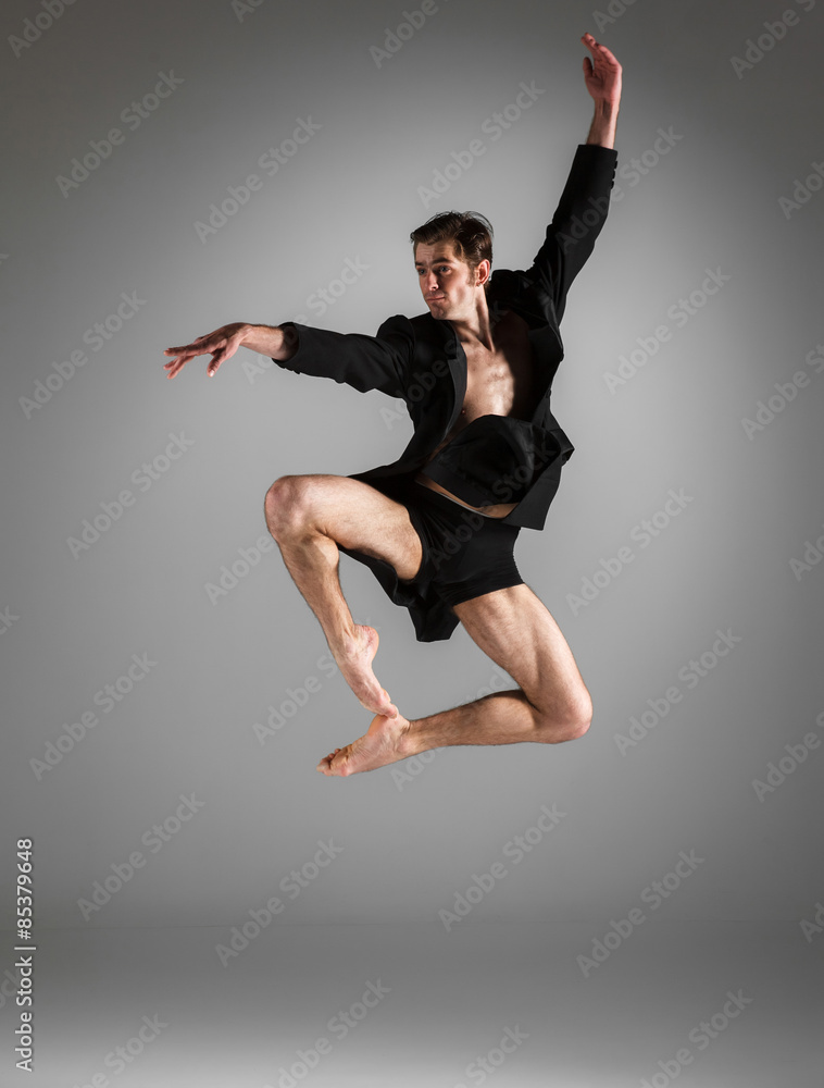 Fototapeta premium The young attractive modern ballet dancer jumping on white