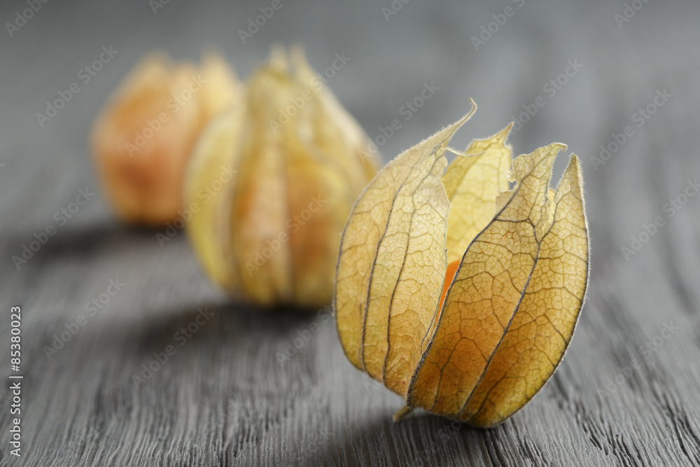 Physalis fruit on oak wooden table Physalis fruit on oak wooden table