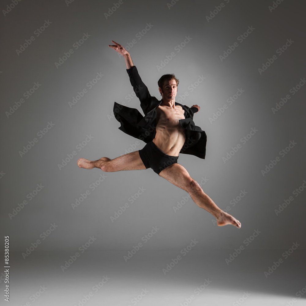 Fototapeta premium The young attractive modern ballet dancer jumping on white