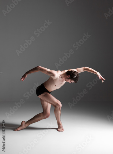 Fototapeta Naklejka Na Ścianę i Meble -  The young attractive modern ballet dancer on white background