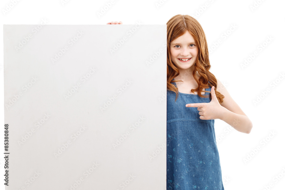 Smiling little girl pointing white box Smiling little girl pointing white box