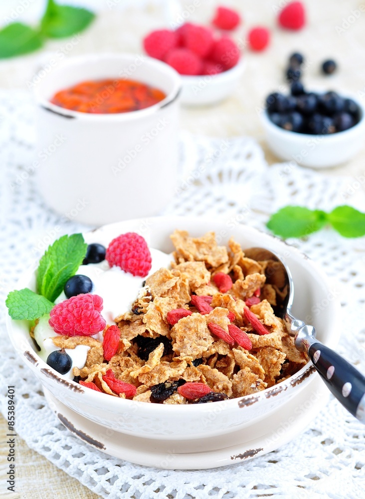 Healthy breakfast, yogurt with granola and berries on the white table Healthy breakfast, yogurt with granola and berries on the white table