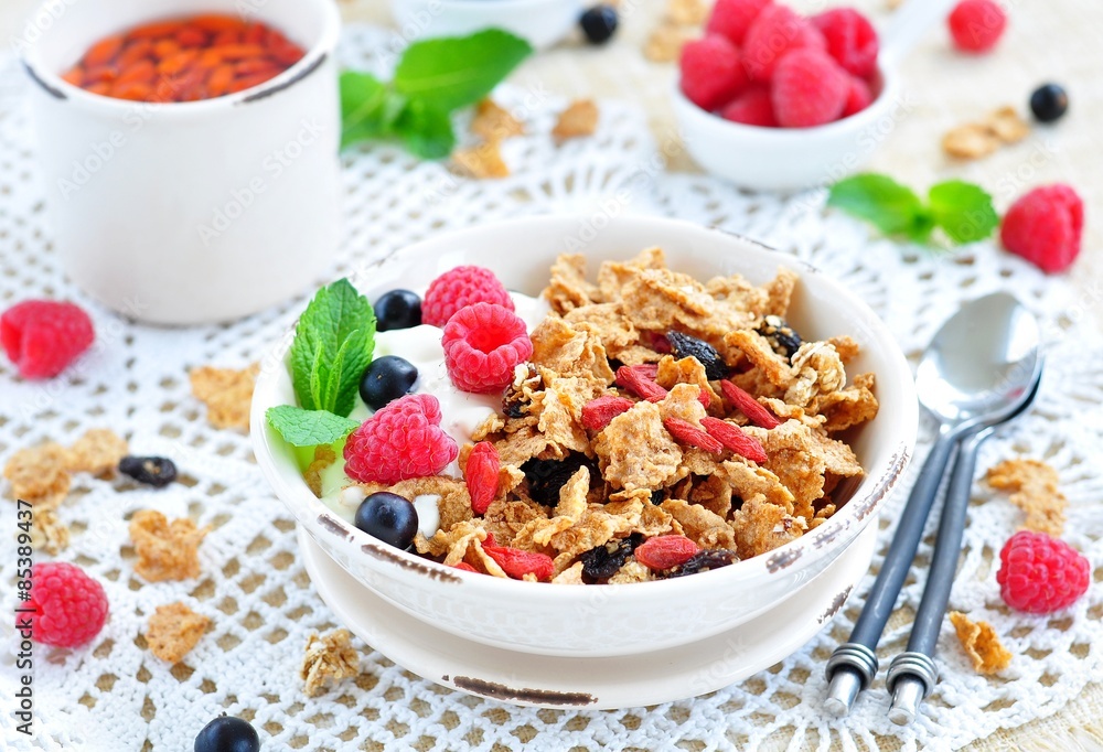 Healthy breakfast, yogurt with granola and berries on the white table Healthy breakfast, yogurt with granola and berries on the white table