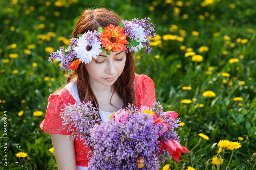 beautiful woman sitting in a wreath on a meadow beautiful woman sitting in a wreath on a meadow