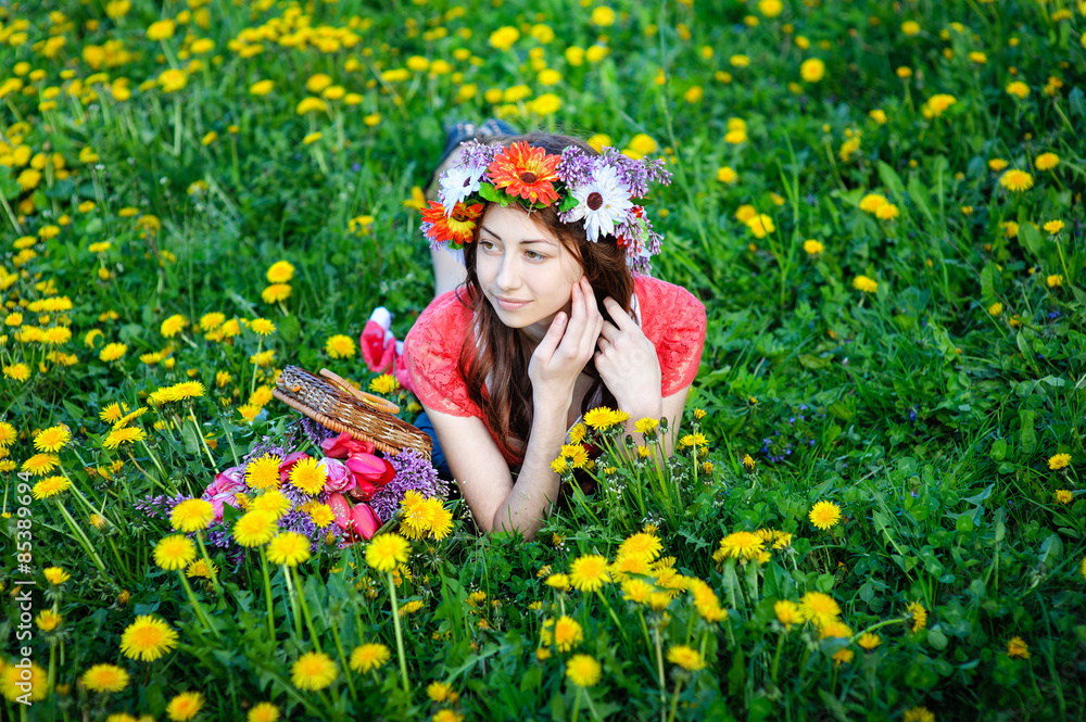 beautiful woman sitting in a wreath on a meadow beautiful woman sitting in a wreath on a meadow