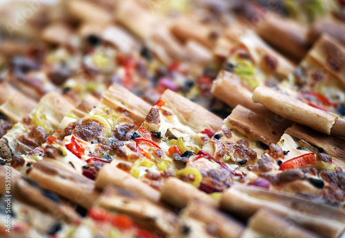 Pides, the Turkish pastry with vegetables on a wooden cutting board