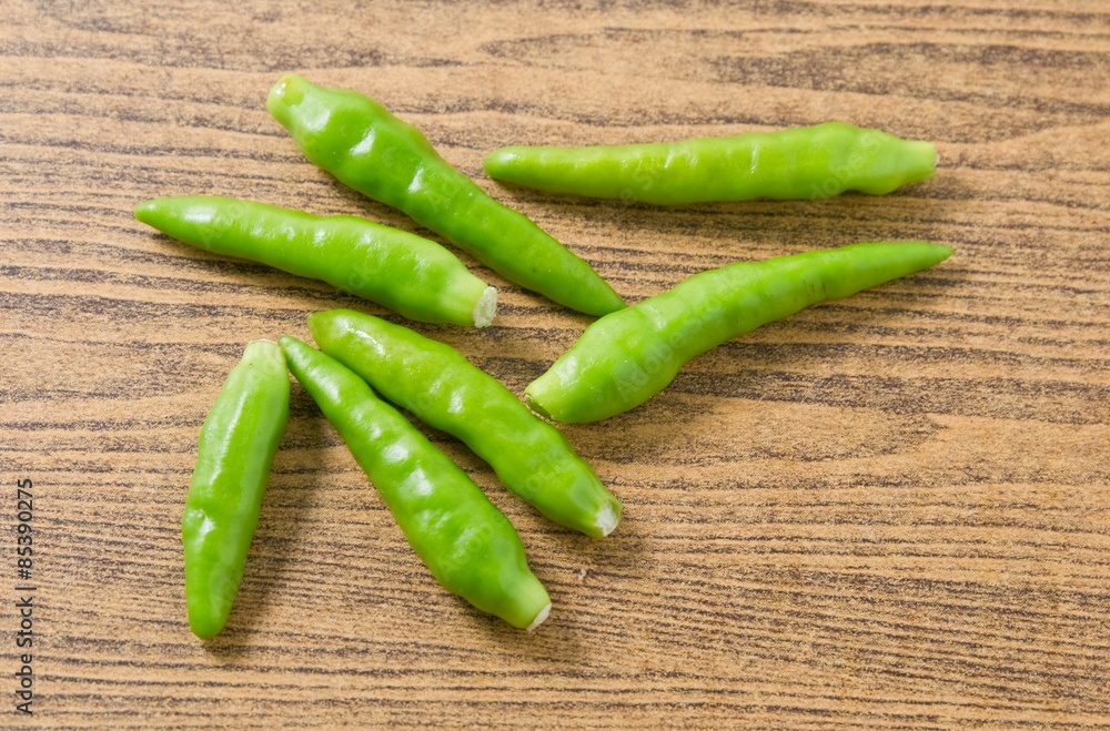 Fresh Green Chili Pepper on A Wooden Table Fresh Green Chili Pepper on A Wooden Table