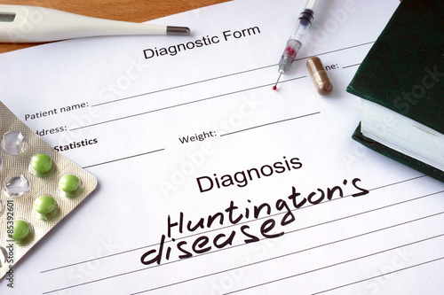 Diagnostic form with Diagnosis Huntington disease  and pills.  photo
