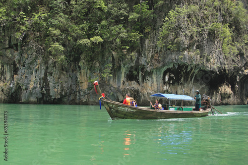 Langtailboat by Karst rock formations in the Bay of Phang Nga, Thailand, Southeast Asia