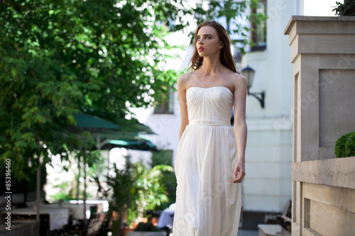 Portrait of beautiful model woman in wearing white dress © Andrey_Arkusha