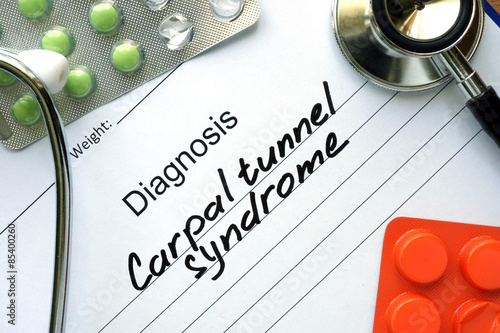 Diagnostic form with diagnosis Carpal tunnel syndrome and pills. photo